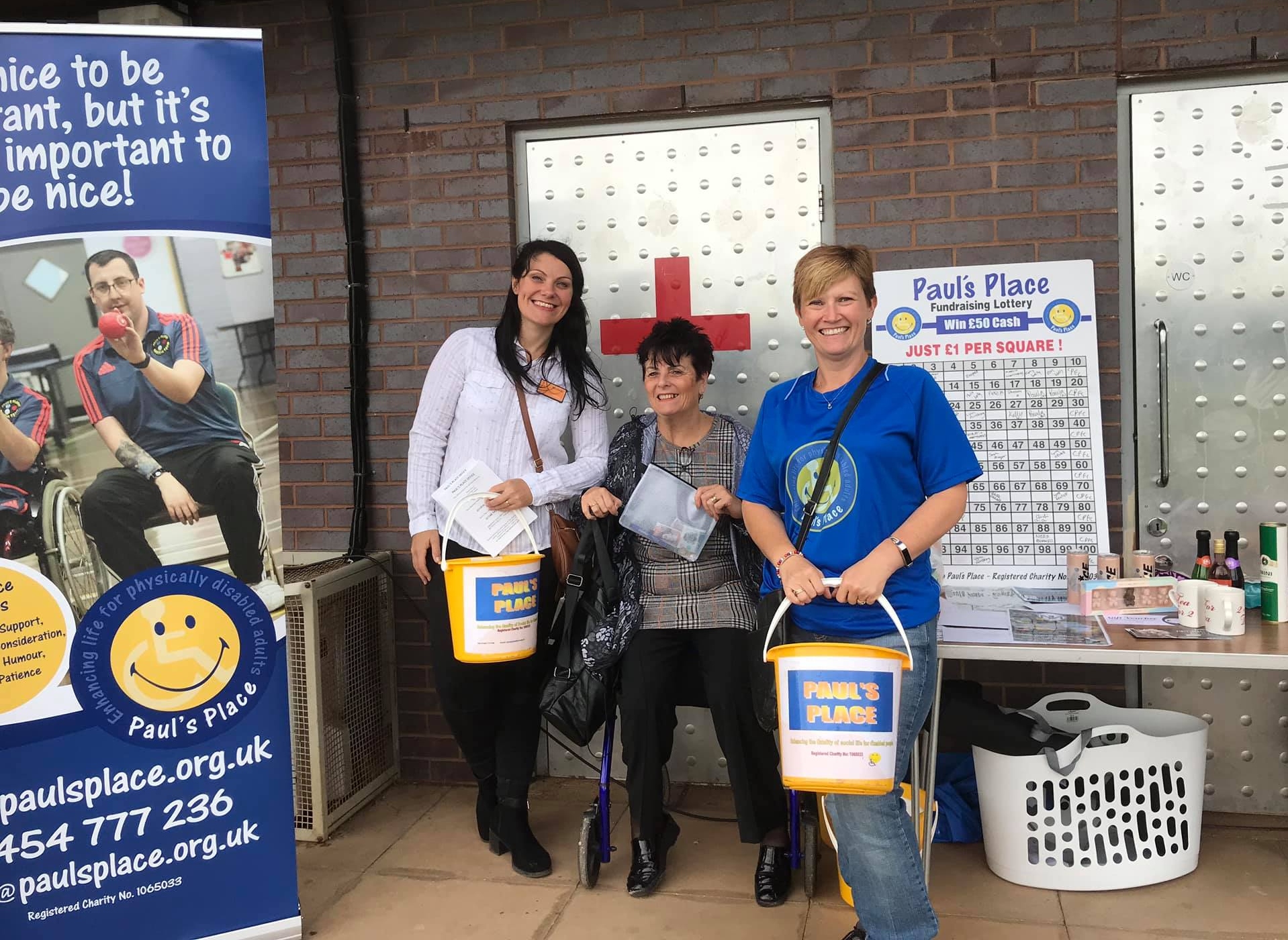 Staff and members fundraising with buckets and banners