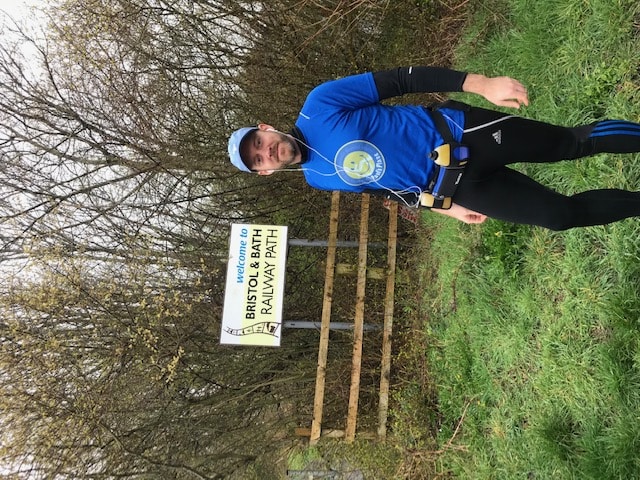 Daniel Curl standing infront of the bristol to bath railway path sign