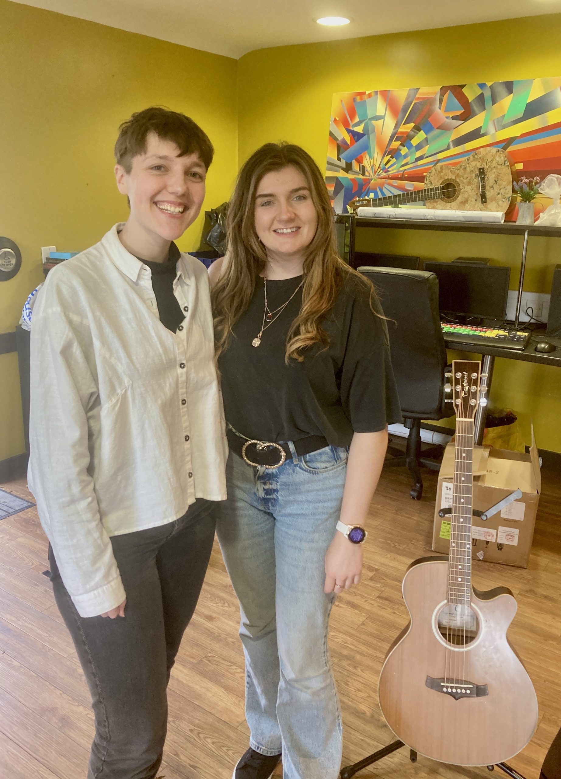 Beth and bethany in the day facility. next to them a guitar.