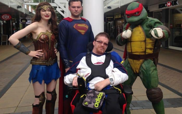 Paul's Place member, Dean Graham, photo with super heroes.